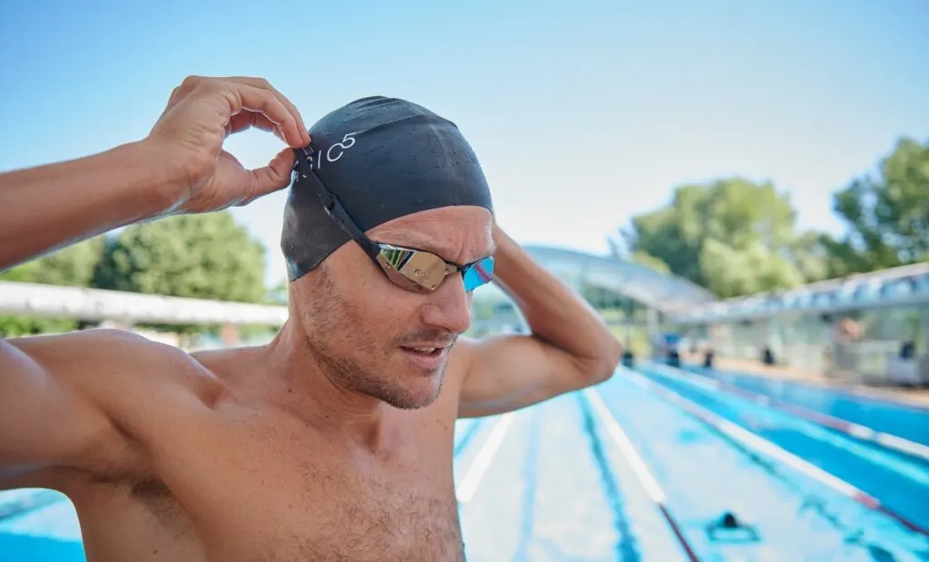 swim cap and goggles are essential swim gear for triathletes